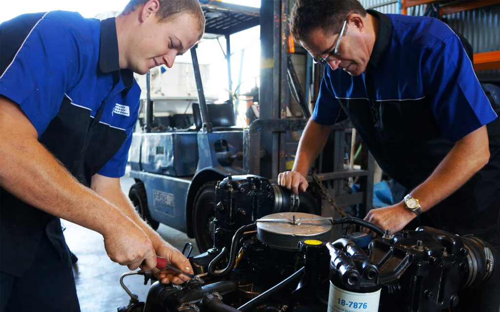 Marine workers performing engine maintenance